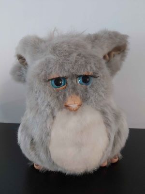 A 2005 emototronic Furby with blue eyes, grey fur and a not very perceptibly pink tummy.