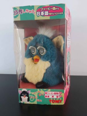 An original 1998 era dragon green Furby in an original box. The box text is all in Japanese.