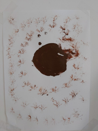 A painting of a brown blob surrounded by fainter brown shapes that almost look like chicken scratches, probably made with paintbrush experimentation. He told me what this was supposed to be once but I forget, it was much more interesting than one might imagine though!